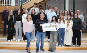 Das Bild zeigt eine Schülerin der BG 13 bei der Übergabe der Spende an die Dehrner Krebsnothilfe e.V.